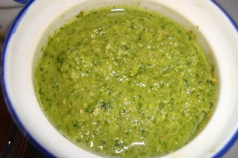A bowl of green sauce is shown.