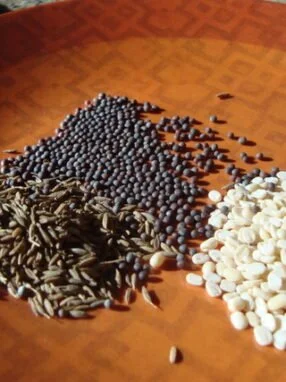 A wooden table with different types of beans on it.