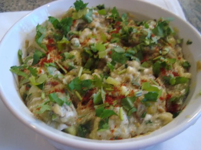 A bowl of food with some green stuff on it