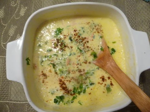 A bowl of soup with wooden spoon in it. Kadhi Yogurt Soup