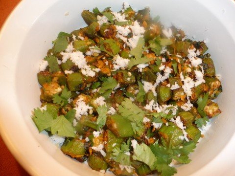 A bowl of food with green vegetables and rice.