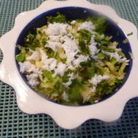 A bowl of rice and vegetables on the table.