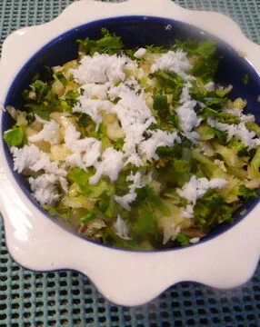 A bowl of rice and vegetables on the table.
