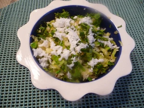 A bowl of rice and vegetables on the table.