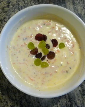 A bowl of cereal with fruit in it.