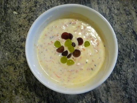 A bowl of cereal with fruit in it.