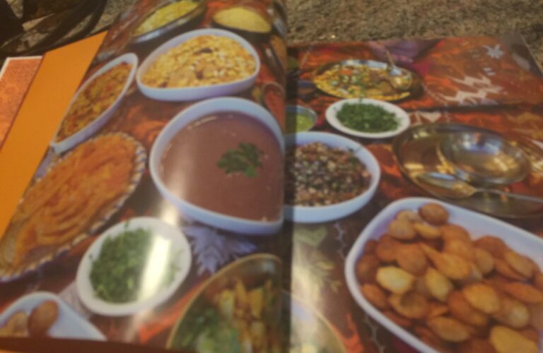 A book with many different dishes of food on it.