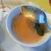 A bowl of soup with a spoon in it.