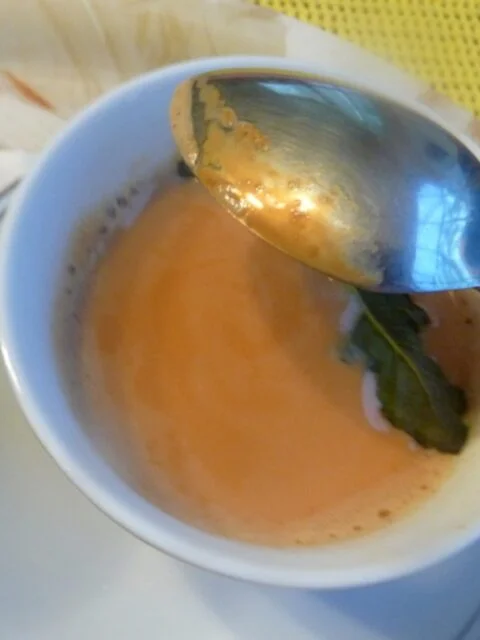 A bowl of soup with a spoon in it.