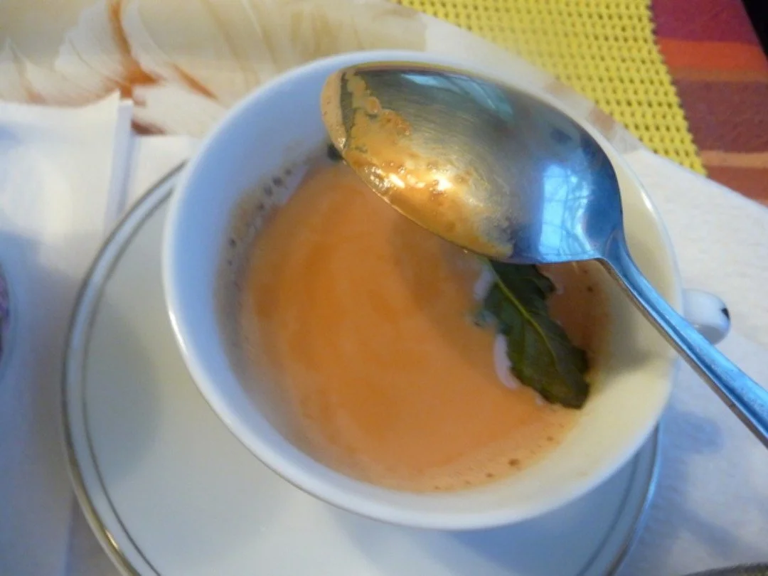 A bowl of soup with a spoon in it.